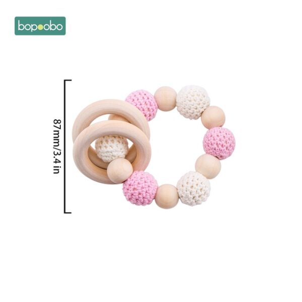 Sonajero circular con bolitas y aros para niña
